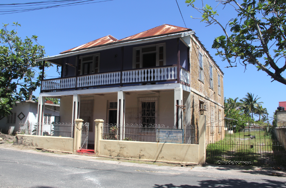 Two story brick and wooden house Two story house with porches at 2 Trelawny Street